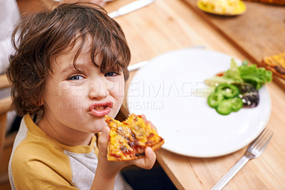 Buy stock photo Boy, child and pizza in portrait at dinner table for eating, food and relax on holiday in family house. Kid, happy and playful in dining room for lunch with nutrition, diet and home for funny face
