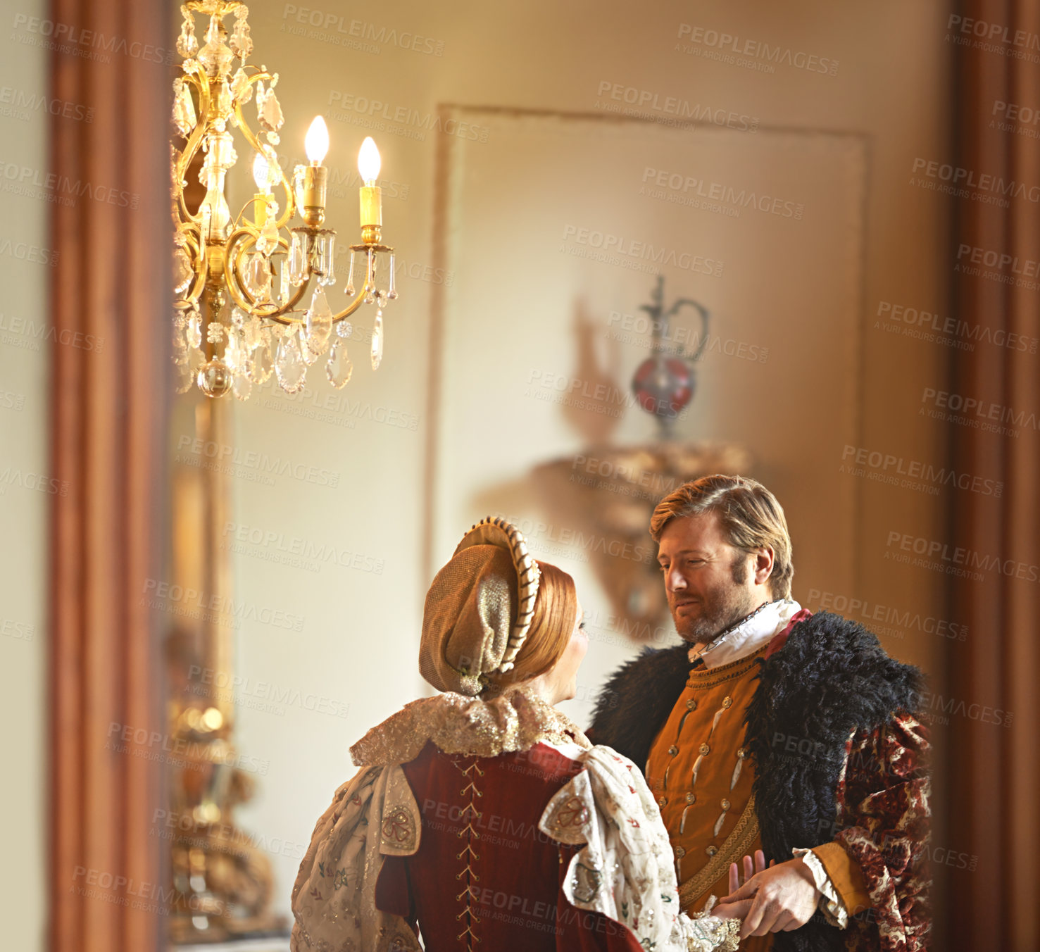 Buy stock photo Victorian, man and woman talking in royal castle together with vintage love, romance and banquet hall. Medieval king, queen or renaissance couple in ballroom holding hands with conversation in palace