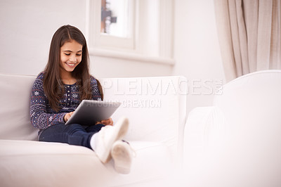 Buy stock photo Relax, house or girl with tablet for elearning, playing games or streaming videos on a movie website. Education, online or female child with technology to download on app or reading ebook on couch