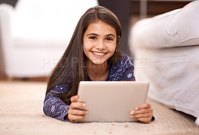 Buy stock photo Floor, portrait or child with tablet for streaming, playing games or watching fun videos on movie website. Girl, house or happy kid with technology to download online or social media app to relax