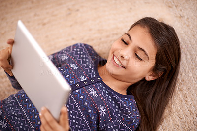Buy stock photo Floor, smile or child with tablet for streaming, playing games or watching fun videos on movie website. Above, house or happy kid with technology to download online or fun social media app to relax