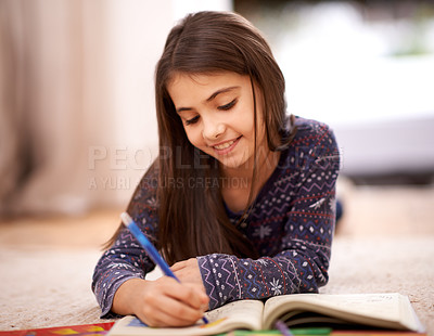 Buy stock photo Girl, coloring book and drawing on floor for sketch in home with learning, development or lying in lounge. Kid, art and education for studying, creativity or relax on carpet at family house in Madrid