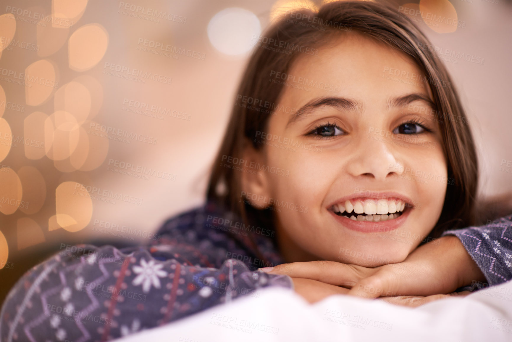 Buy stock photo Home, happy and portrait of child on bed for relaxing, resting and smile in bedroom at night. Youth, blanket and face of young girl with fairy lights for childhood memory, peace and happiness