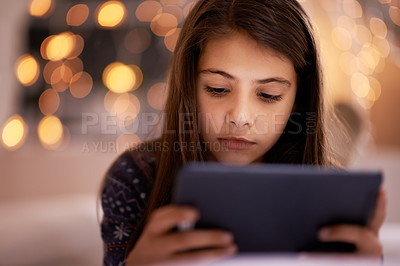 Buy stock photo Home, night or kid with tablet for streaming, playing games or watching fun videos on movie website. Girl, house or young female child with technology to download online or social media app to relax
