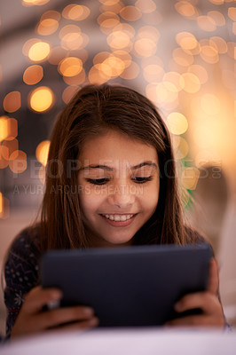 Buy stock photo Home, night or girl with tablet for movies, playing games or watching funny videos on streaming website. Happy, house or child with smile technology to download online or social media app to relax 