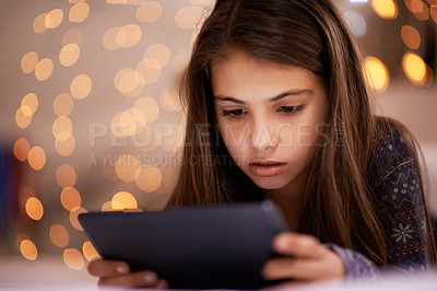 Buy stock photo Home, night or girl with tablet for streaming, playing games or watching videos on a movie website. Internet, house or female child with technology to download online or social media app to relax