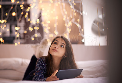 Buy stock photo Thinking, tablet and children with a girl in her home, lying on the living room floor to relax or daydream. Kids, idea and technology with a young female child browsing the internet in her house