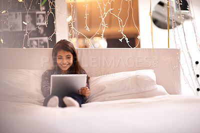 Buy stock photo Girl, child and tablet in bed, happy and relax with tech, ebook for reading and social media at home. Website, cartoon or storytelling app with internet, browse and digital platform for gaming