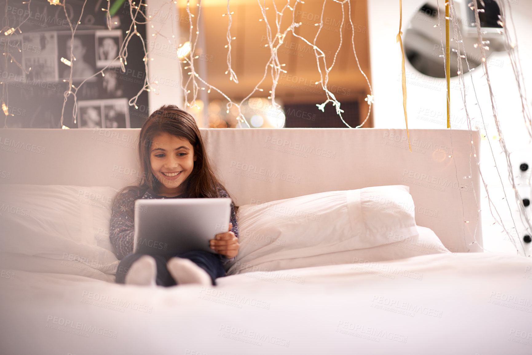 Buy stock photo Girl, child and tablet in bed, happy and relax with tech, ebook for reading and social media at home. Website, cartoon or storytelling app with internet, browse and digital platform for gaming