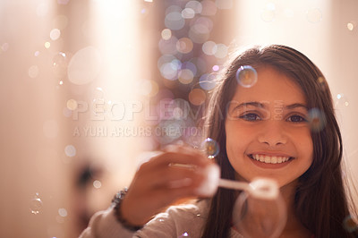 Buy stock photo Home, happy and portrait of child with bubbles for relaxing, resting and playing in bedroom. Youth, smile and face of young girl with soap bubble for childhood memory, playful and happiness in house