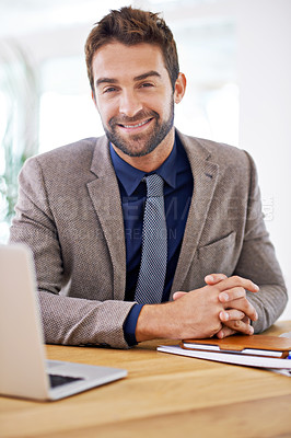 Buy stock photo Shot of a young man sitting in his office
