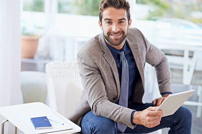 Buy stock photo Shot of a businessman using his digital tablet
