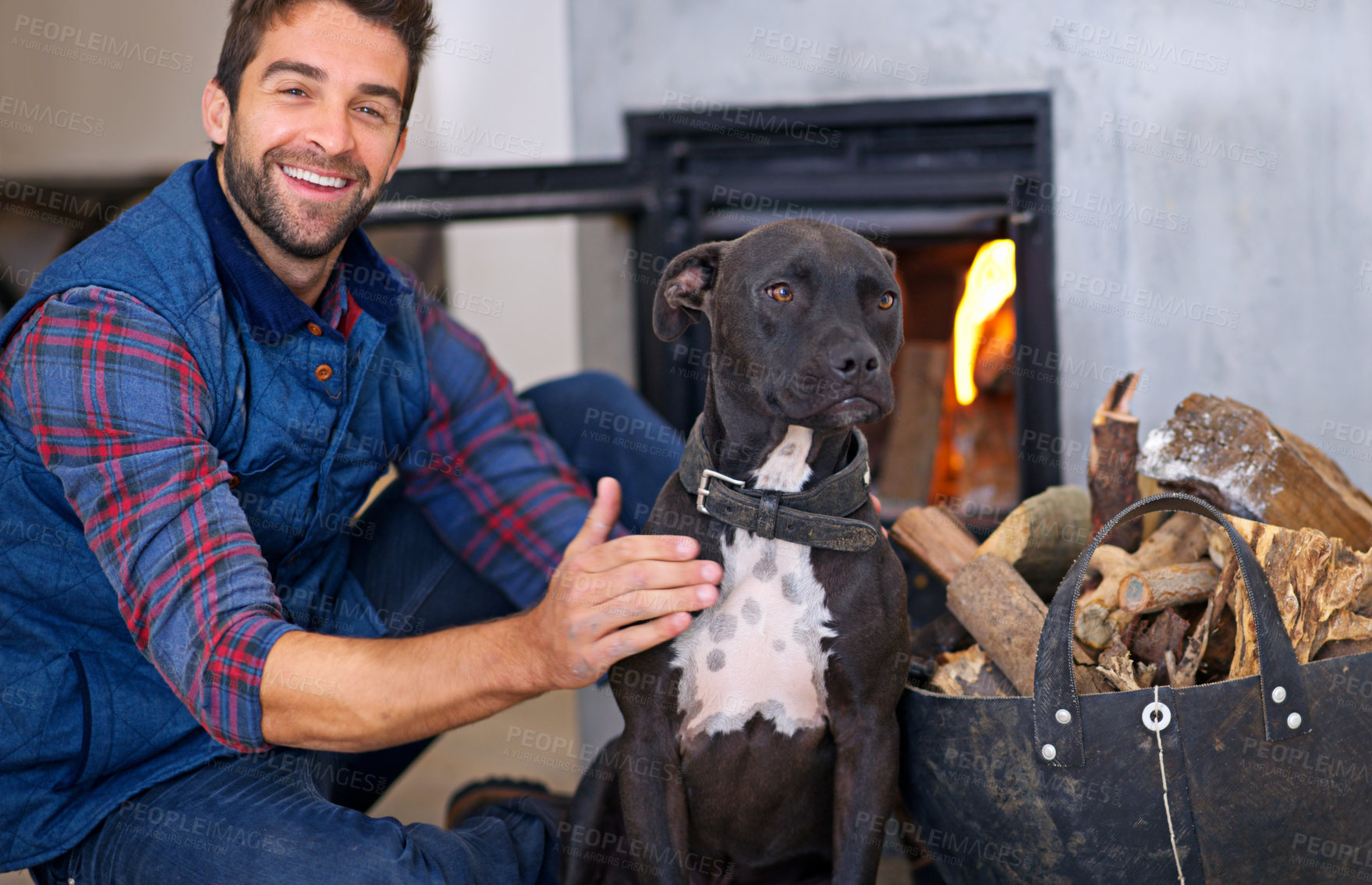 Buy stock photo Fireplace, dog and portrait of man with fire in home for heat, warmth and light in winter. Flame, wood and person with pet bonding with firewood for comfort, cozy and relaxing house in living room