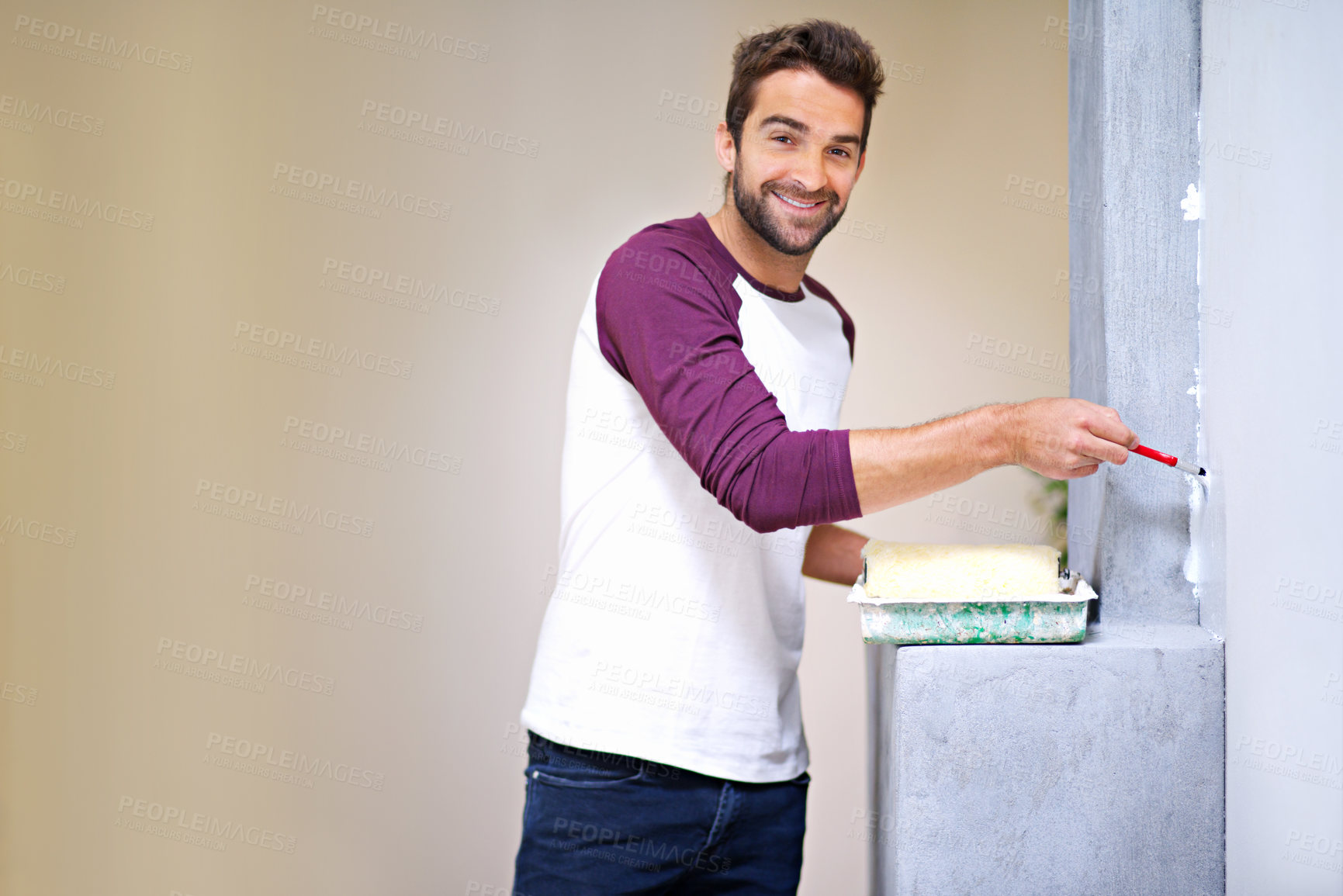 Buy stock photo Painting, happy and portrait of man in home for renovation, remodeling and maintenance in house. Interior design, construction and person with paintbrush, roller and white paint for DIY project