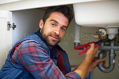 Buy stock photo Man, portrait and plumber with wrench for pipe repair, service or fix in home maintenance or indoor leak. Male person or handyman smile with water damage or sink of plumbing professional at the house