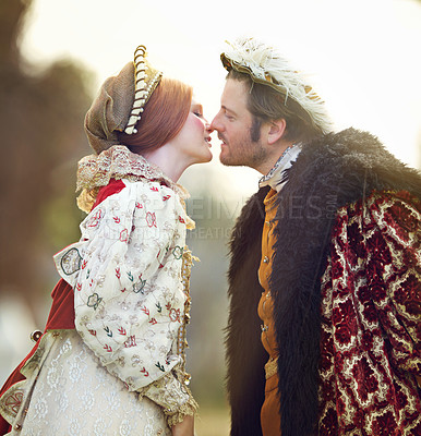 Buy stock photo Medieval, king and couple kiss in history with renaissance fashion outdoor with marriage and love. Vintage, garden and royal leader with queen together on a lawn with romance and theater costume 