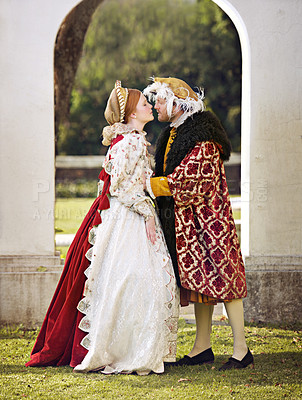 Buy stock photo Medieval, king and couple kiss in marriage with renaissance fashion outdoor with marriage and love. Vintage, garden and royal leader with queen together on lawn with victorian and theater costume 