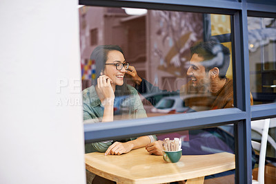 Buy stock photo Happy couple, bonding and relax with date at cafe for conversation or enjoying romance at indoor restaurant. Man and woman with smile by window at coffee shop for social, chatting or talk on mockup