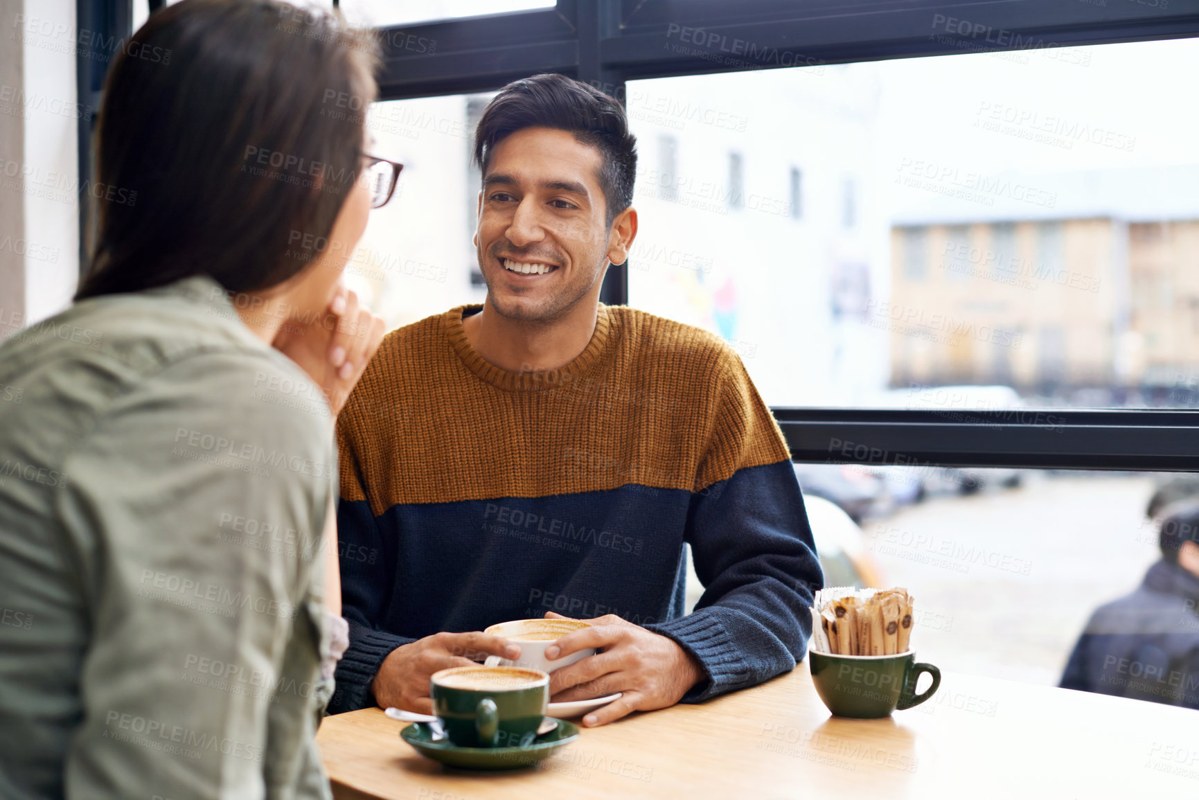Buy stock photo Couple, date and coffee shop with happy conversation and talking together with hot drink in a cafe. Man, smile and speaking about relationship in a restaurant with tea or cappuccino at a table 