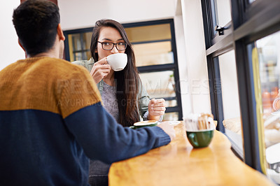 Buy stock photo Couple, relax and date with coffee at cafe for morning conversation, bonding or romance at indoor restaurant. Man and woman drinking or enjoying caffeine, latte or cappuccino by window at the shop
