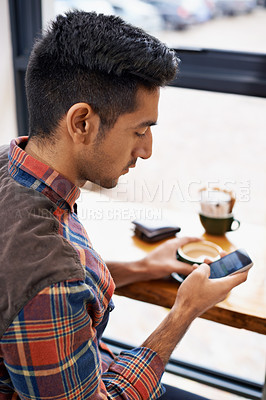 Buy stock photo Man, coffee and typing with phone for social media, communication or networking at indoor cafe. Male person on mobile smartphone for online chatting, texting or app by window at cafeteria restaurant