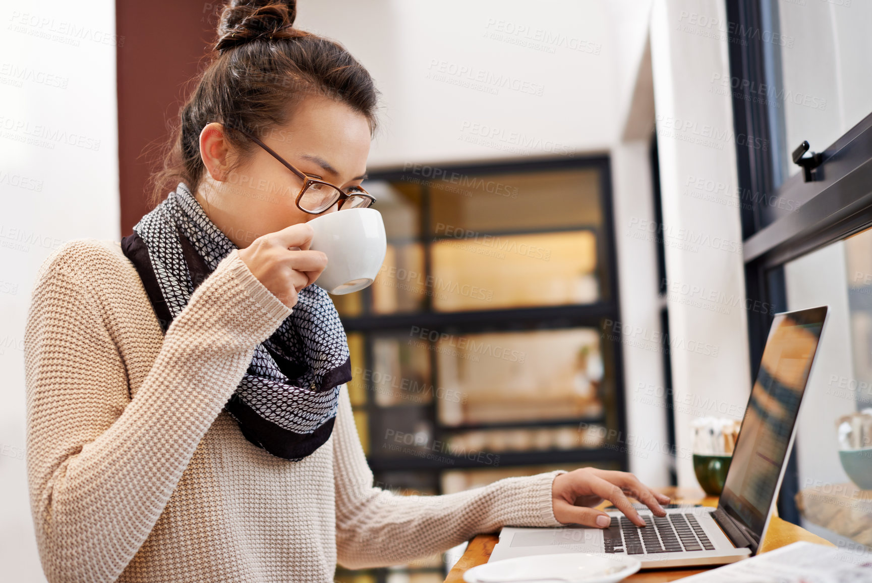 Buy stock photo Remote work, woman drinking coffee and laptop for freelance writer at cafe store. Social media or networking, reading emails and female student or content creator on mobile device in restaurant 