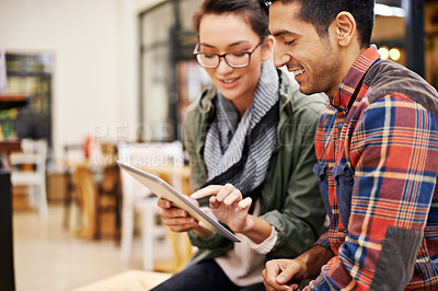 Buy stock photo Cropped shot of a young couple using a digital tablet together