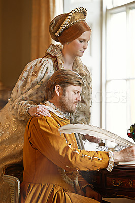Buy stock photo Couple, feather and writing a letter, together and relax in home for history in noble palace. People, love and bonding or notes in journal for plan, renaissance and aesthetic for support in marriage