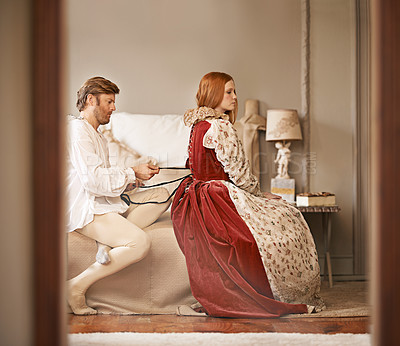 Buy stock photo Couple, noble and bedroom with dressing, marriage and luxury with royal relationship. King, queen and royalty with palace bed chamber, wealth and historical ruler together with bonding and lady care