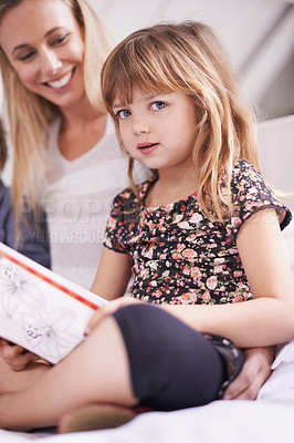Buy stock photo Reading, mother and daughter on sofa with book for bonding, teaching and learning together in home. Relax, mom and child relax on couch for bedtime storytelling, smile and happy family in living room