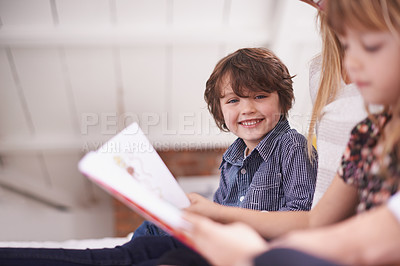 Buy stock photo Reading, mother and children on sofa with smile for bonding, teaching and learning together in home. Woman, son and daughter relax on couch with storytelling, book and happy family in living room