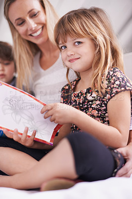 Buy stock photo Reading, mom and daughter on sofa with book for bonding, teaching and learning together in home. Story, mother and child relax on couch for bedtime storytelling, smile and happy family in living room