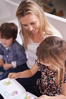 Buy stock photo Reading, woman and children on sofa with book for bonding, teaching and learning together in home. Mother, son and daughter relax on couch with storytelling, smile and happy family in living room