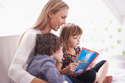 Buy stock photo Reading, mother and children on sofa with story for bonding, teaching and learning together in home. Woman, son and daughter relax on couch with storytelling book, smile and happy family in house