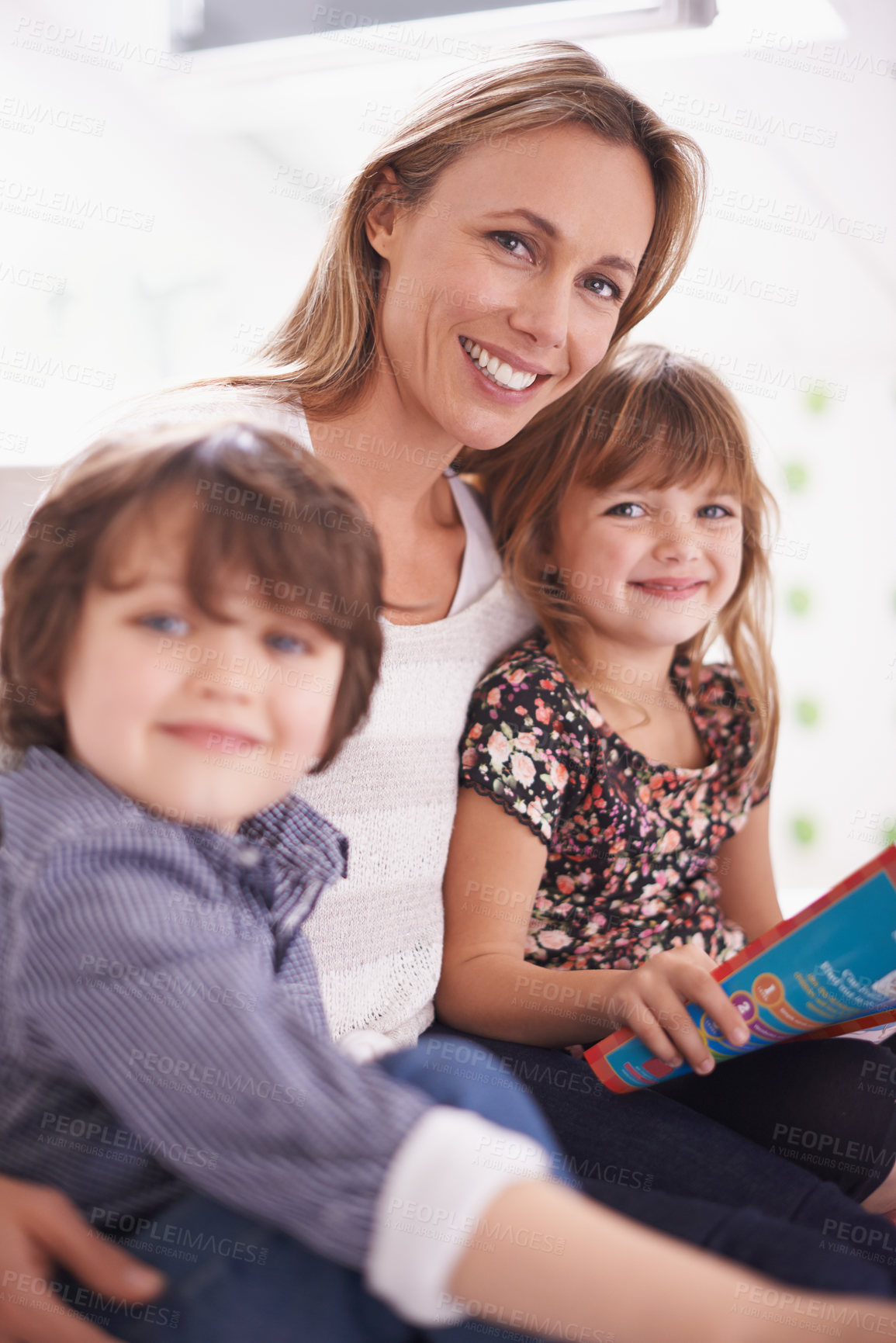 Buy stock photo Portrait, mother and children on sofa reading book with bonding, teaching and learning together in home. Mom, son and daughter relax on couch with storytelling, smile and happy family in living room