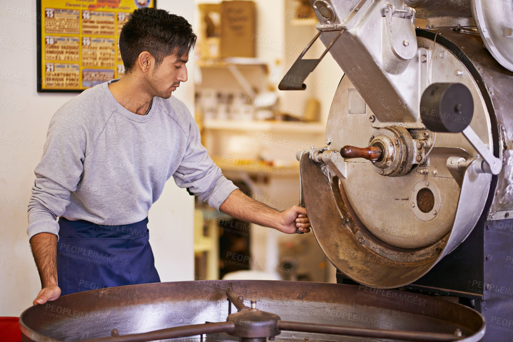 Buy stock photo Coffee, production and man with machine for roasting with blending, small business and quality control. Entrepreneur, barista or roaster with beans at cafe, sustainable startup and espresso process