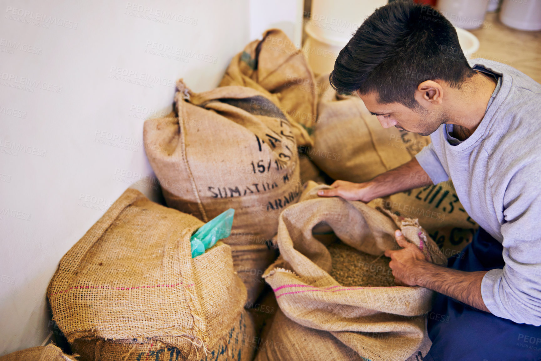 Buy stock photo Shot of a man looking at raw coffee beans