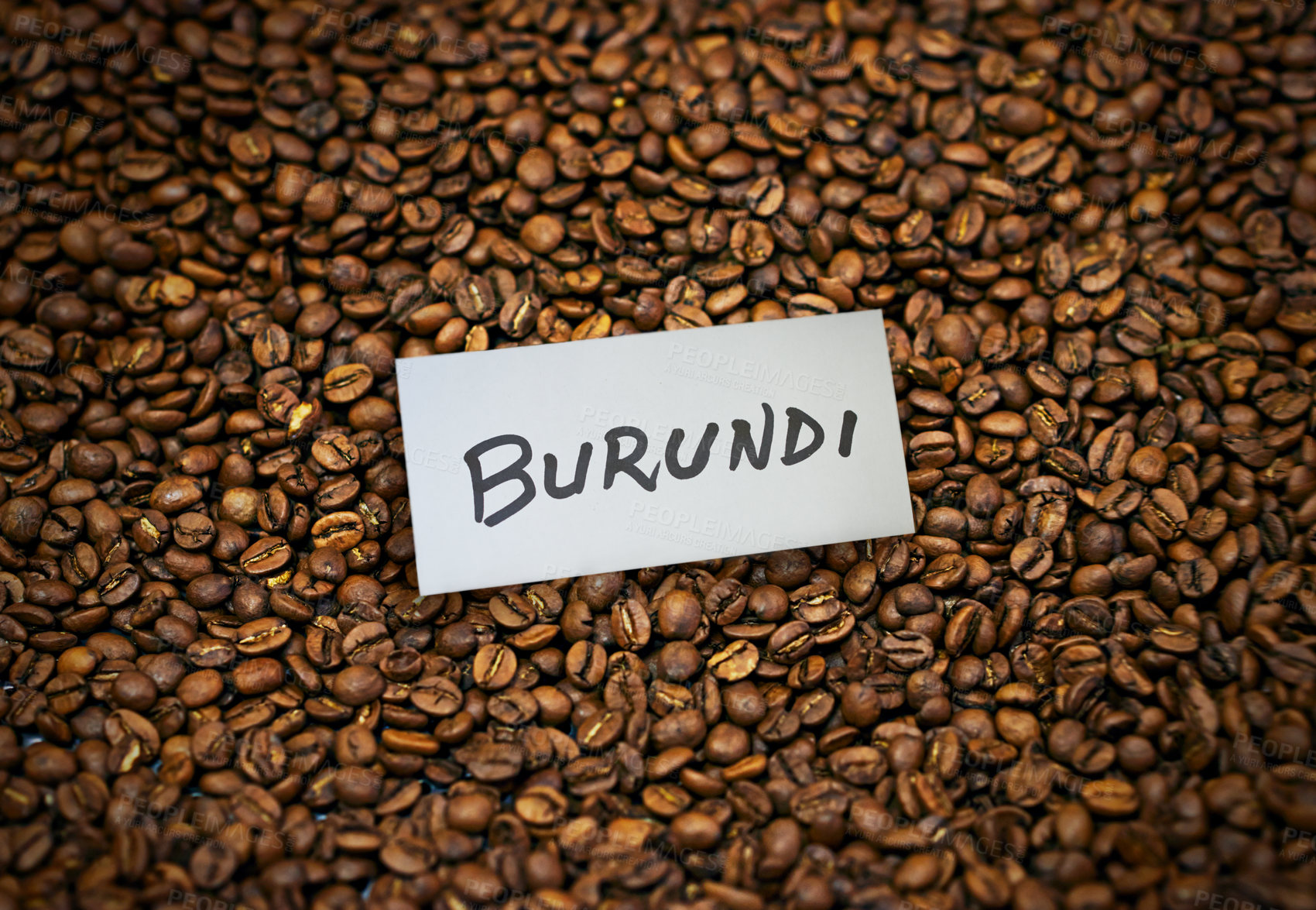Buy stock photo Coffee, roasted beans and closeup with product of Burundi for export, trading and sustainability. Natural caffeine, supply chain and manufacturing with label, tag and logistics for global shipping