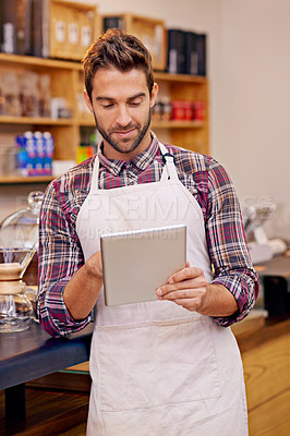 Buy stock photo Man, barista and tablet for reading in coffee shop with smile, thinking or communication for online order. Person, waiter and digital touchscreen for typing, click or check for ecommerce in cafeteria