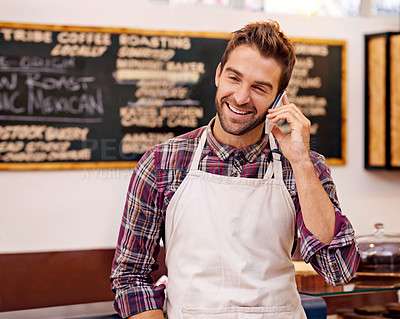 Buy stock photo Man, waiter and happy for phone call in a coffee shop to talk to contact for drink order at small business. Person, barista and smartphone for listening to chat, networking and smile in a cafeteria