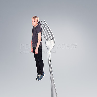 Buy stock photo Depression, boy and sad on fork in studio, abstract and teenager with problem or mental health. Child, silver cutlery and kitchenware for weird concept of anxiety and adolescent  with fear or worry