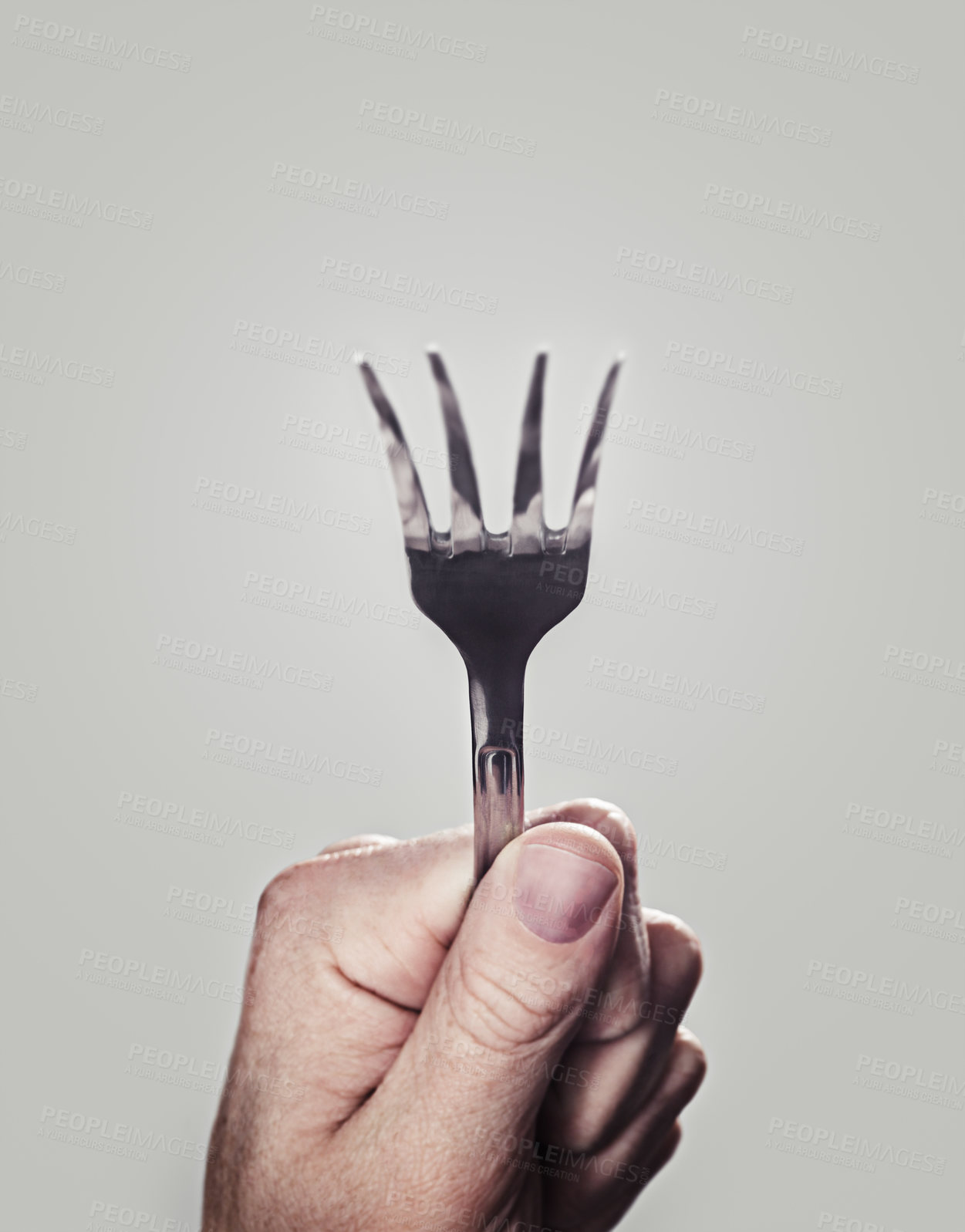 Buy stock photo Bending, fork and hand with closeup, person and utensils with kitchen tool on a white studio background. Mockup space, promotion and model with superpower and magic with design, artistic and creative