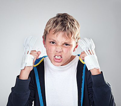 Buy stock photo Portrait, angry and boy with fist, child and expression with frustrated on grey studio background. Face, bully and kid with forks for claws and reaction with costume and aggressive with rage or fight