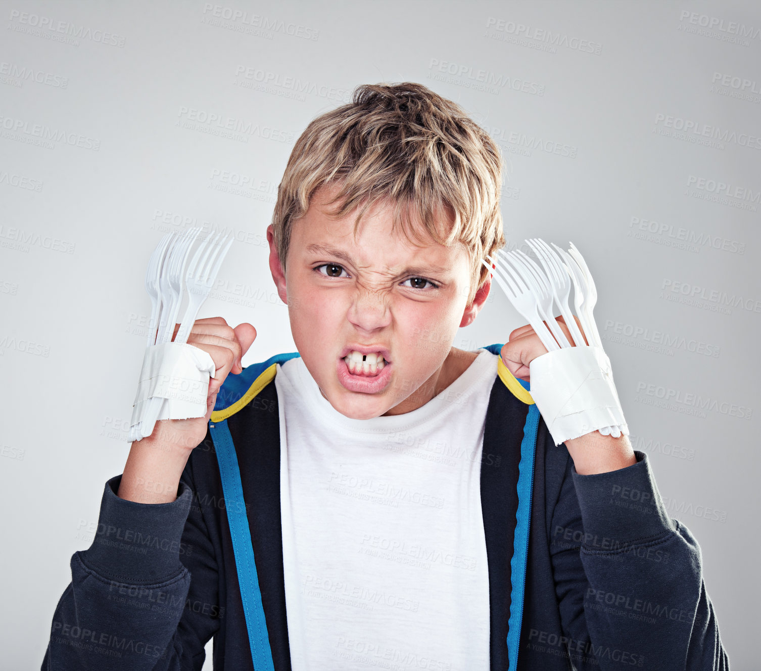 Buy stock photo Portrait, angry and boy with fist, child and expression with frustrated on grey studio background. Face, bully and kid with forks for claws and reaction with costume and aggressive with rage or fight