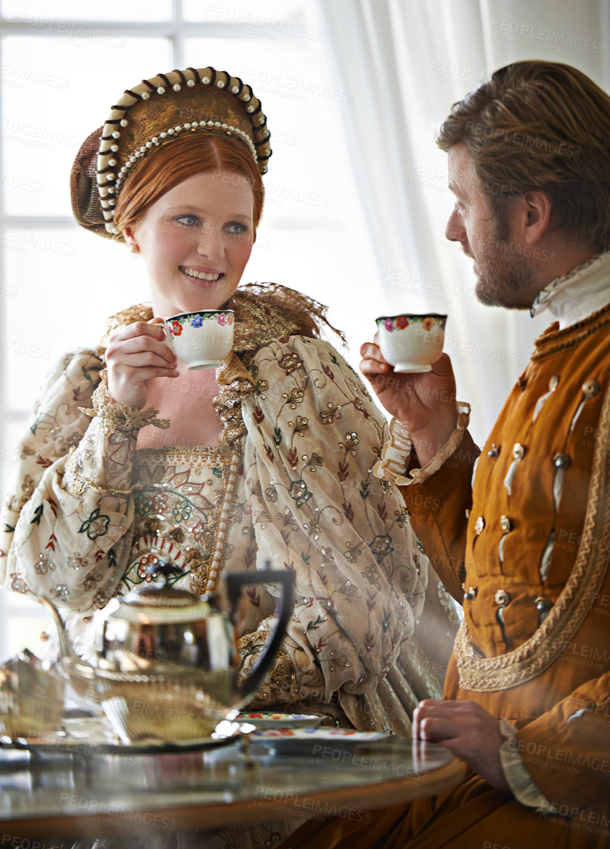 Buy stock photo King, queen and couple with tea for royalty, smile and conversation in vintage clothes with style in castle. Woman, man and drink together in morning with Victorian fashion at regal palace in UK