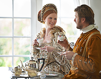 Buy stock photo King, queen and tea for royalty in castle, smile and conversation in vintage clothes with style at breakfast. Woman, man and drink together in morning with Victorian fashion at regal palace in UK