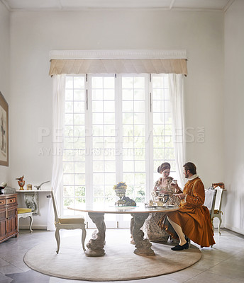 Buy stock photo King, queen and royal couple with tea in castle, smile and talk in vintage clothes with luxury at breakfast. Woman, man and people with drink in morning with Victorian fashion at regal palace in UK
