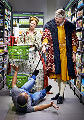 Buy stock photo A king threatening an employee in a supermarket with his sword
