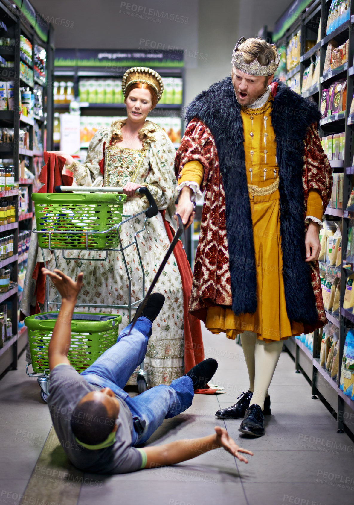 Buy stock photo A king threatening an employee in a supermarket with his sword