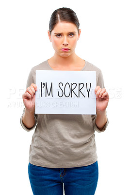 Buy stock photo A young woman holding a board with the words 'I'm sorry'